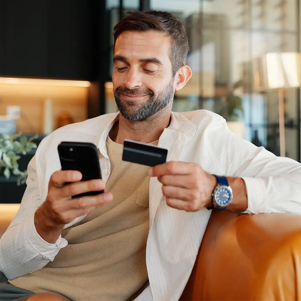 Man with card and phone